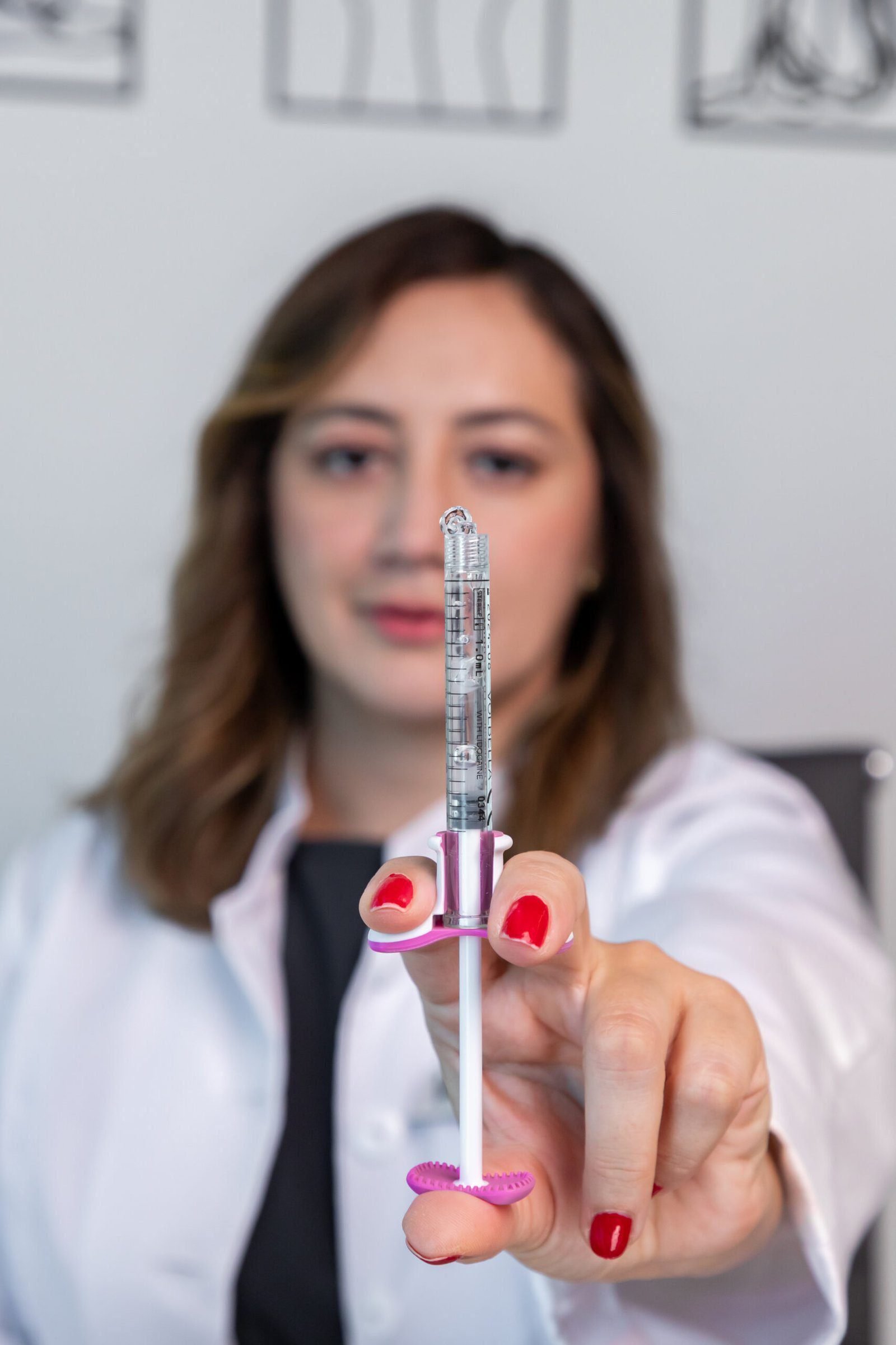 A syringe filled with hyaluronic acid filler, ready to be used for lip injections or under-eye filler treatments.