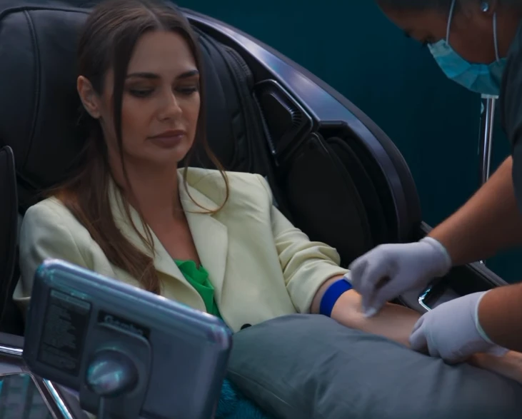 A relaxed patient receiving a customized IV infusion in a modern clinic setting.