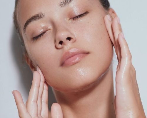 A woman with glowing, radiant skin after receiving a skin booster treatment.