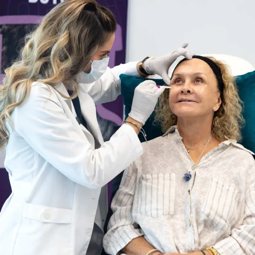 Woman smiling with smooth forehead after Botox treatment.