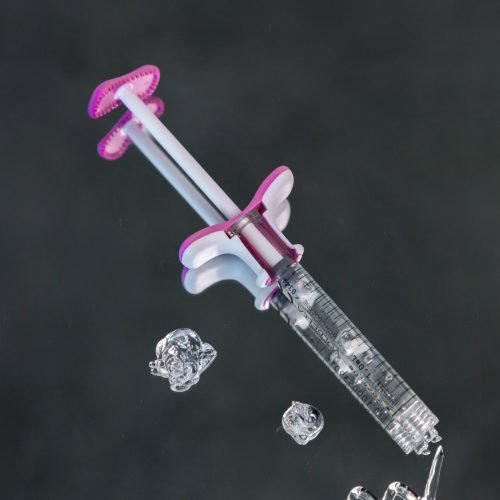 A syringe filled with hyaluronic acid filler, ready to be used for lip injections or under-eye filler treatments.