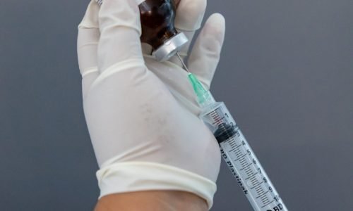 A close-up of an IV bag with vitamins and minerals being infused.