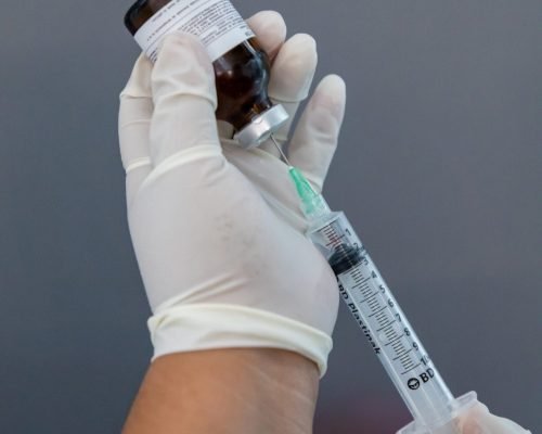 A close-up of an IV bag with vitamins and minerals being infused.