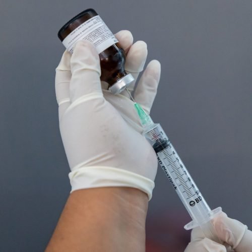 A close-up of an IV bag with vitamins and minerals being infused.