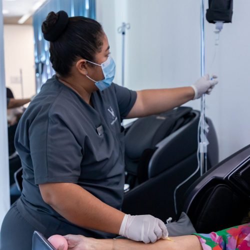 A person relaxing comfortably while receiving an IV infusion.